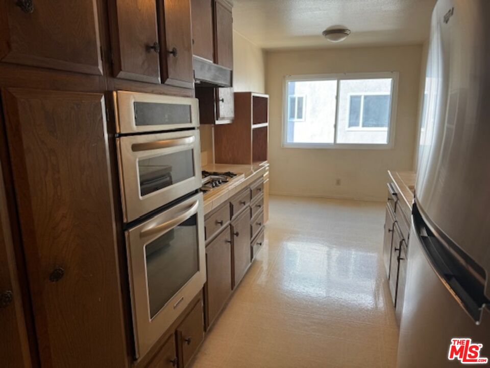 4351 Alla Road, Unit 8 Marina del Rey, CA 90292 - Photo 10 of 31 a kitchen with stainless steel appliances granite countertop a refrigerator and a stove