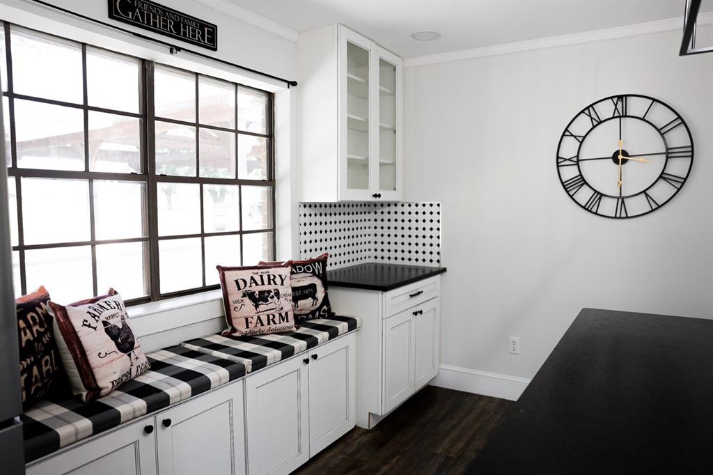 10575 Friendship Road Pilot Point, TX 76258 - Photo 25 of 32 Built-in window bench with storage cabinetry and black and white plaid cushions