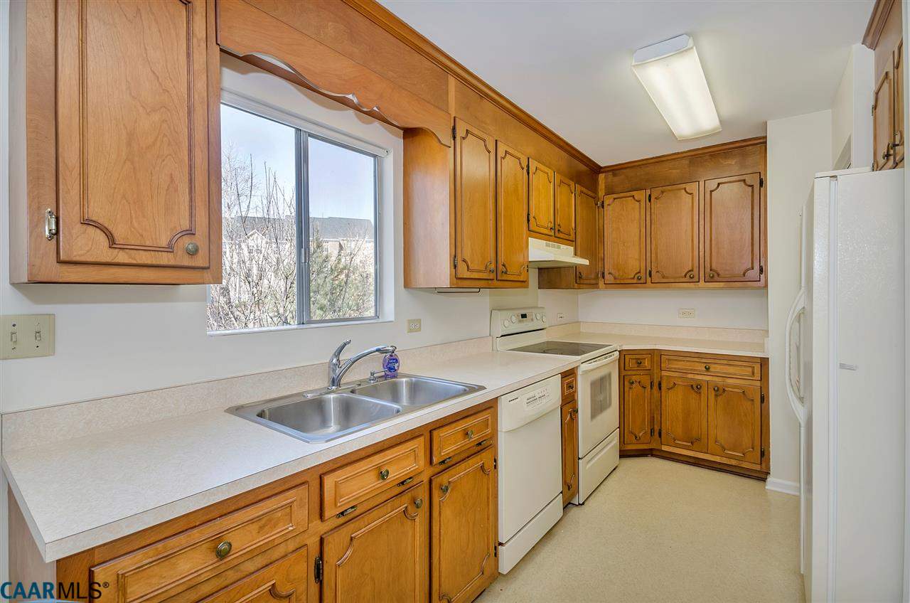 1625 Trailridge Road Charlottesville, VA 22903 - Photo 5 of 24 a kitchen with stainless steel appliances granite countertop white cabinets a sink and a window