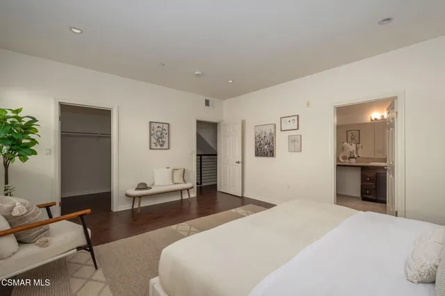 a bedroom with a bed and a couch