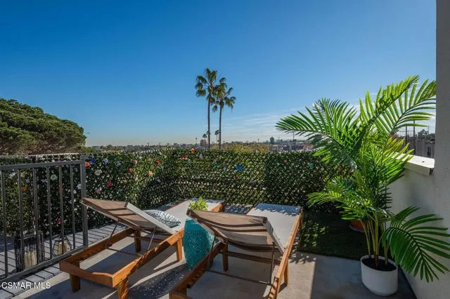 a view of a chairs and table in patio