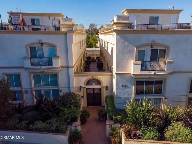 a front view of a residential apartment building with a yard
