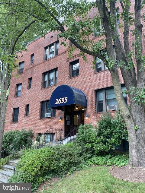 2655 41st Street Northwest, Unit 202 Washington, DC 20007 - Photo 1 of 2 a front view of a house with a yard and trees