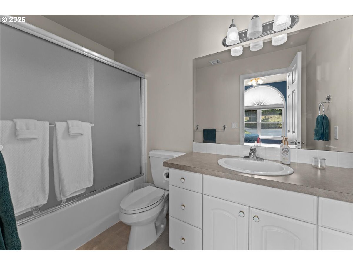 37123 Northeast Reed Road Corbett, OR 97019 - Photo 35 of 48 a bathroom with a granite countertop sink a toilet and a mirror