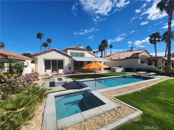 a view of a house with pool porch and sitting area