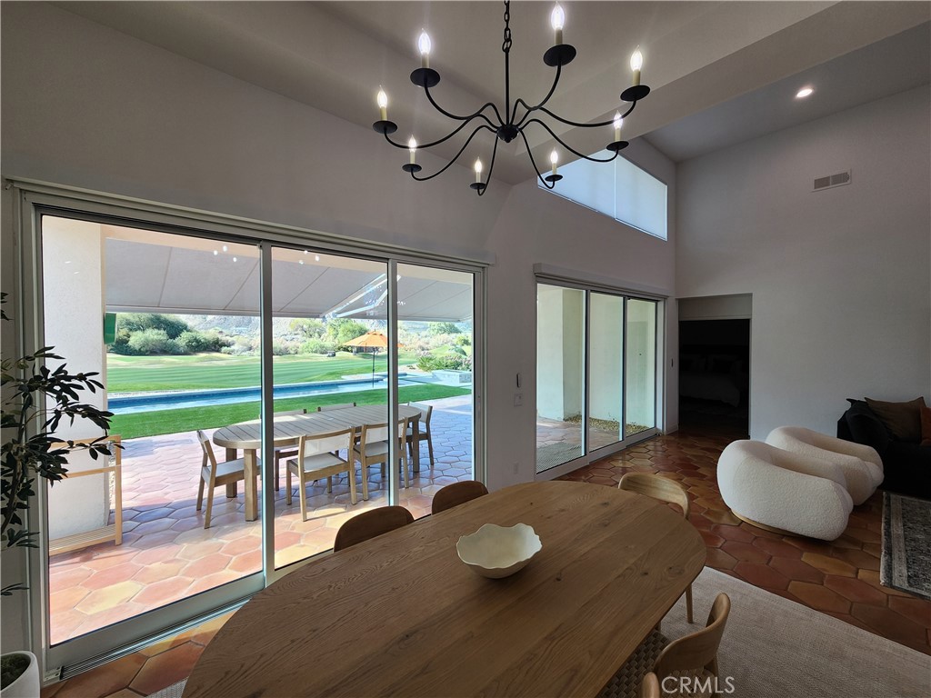 56989 Merion La Quinta, CA 92253 - Photo 11 of 37 a view of a dining room with furniture wooden floor and chandelier
