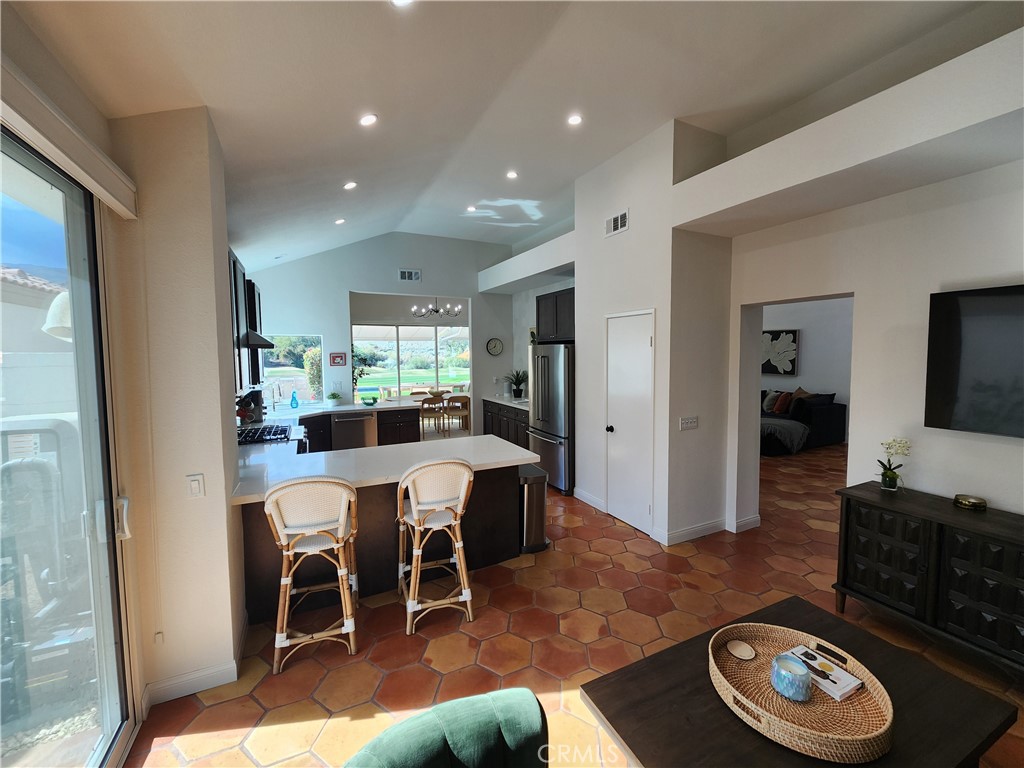 56989 Merion La Quinta, CA 92253 - Photo 13 of 37 a living room with furniture and a dining table with kitchen view