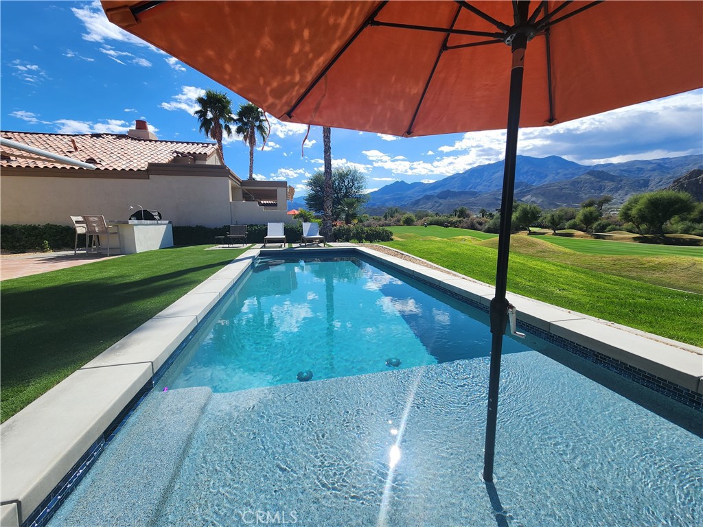 56989 Merion La Quinta, CA 92253 - Photo 18 of 37 a view of a swimming pool with a yard