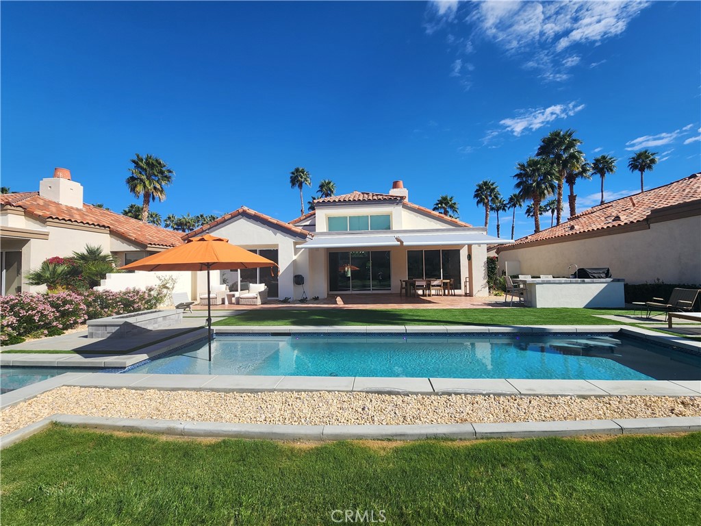 56989 Merion La Quinta, CA 92253 - Photo 19 of 37 a front view of a house with a garden and swimming pool