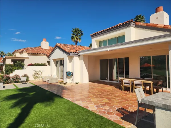 a front view of house with yard and swimming pool