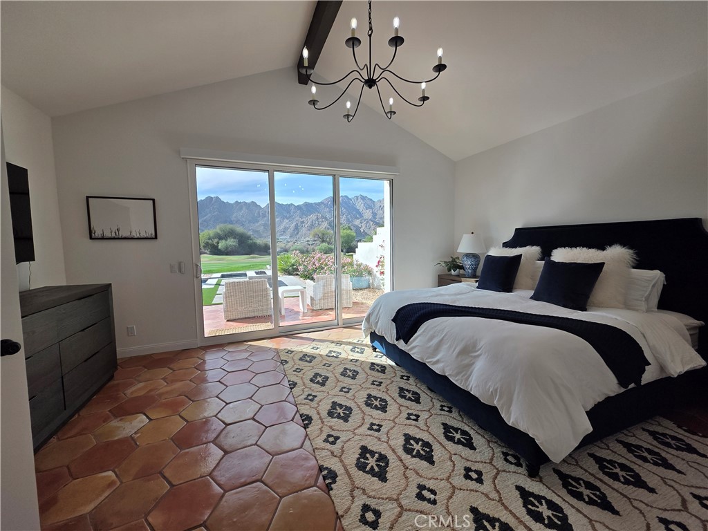 56989 Merion La Quinta, CA 92253 - Photo 24 of 37 a bedroom with a large bed and a window