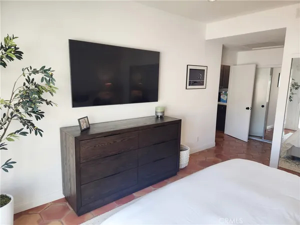 a bedroom with a bed and a mirror