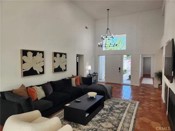 a living room with furniture and a chandelier