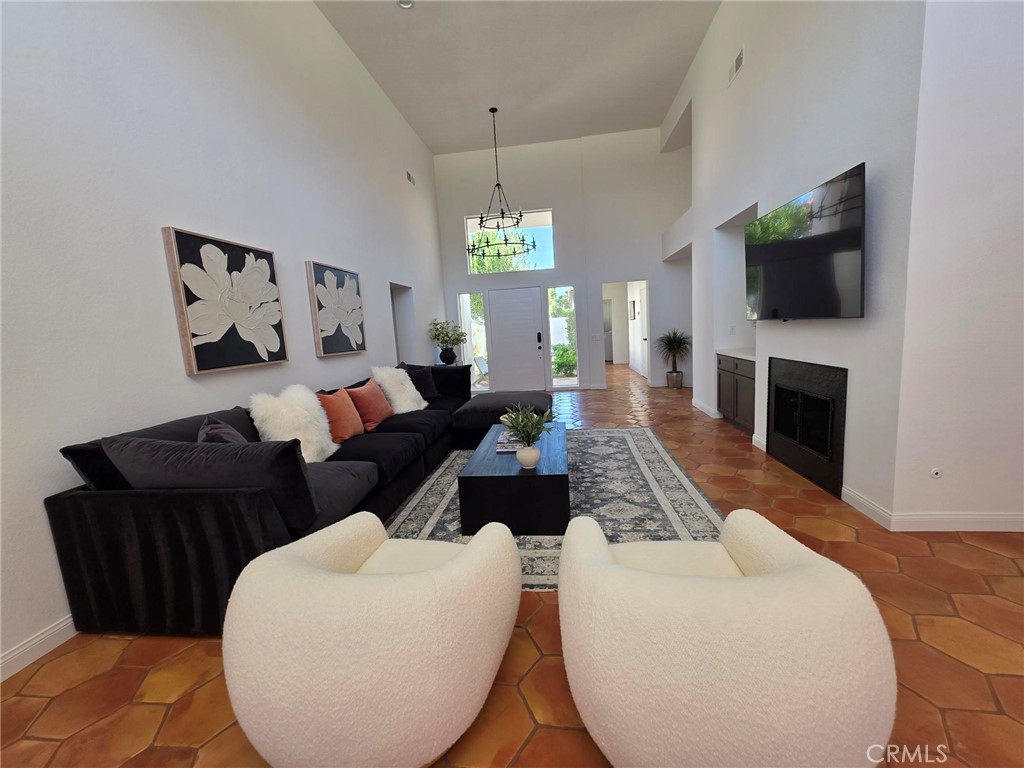 56989 Merion La Quinta, CA 92253 - Photo 7 of 37 a living room with furniture a flat screen tv and a fireplace
