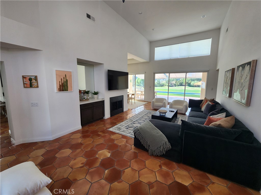 56989 Merion La Quinta, CA 92253 - Photo 8 of 37 a large bedroom with a bed flat screen tv and window