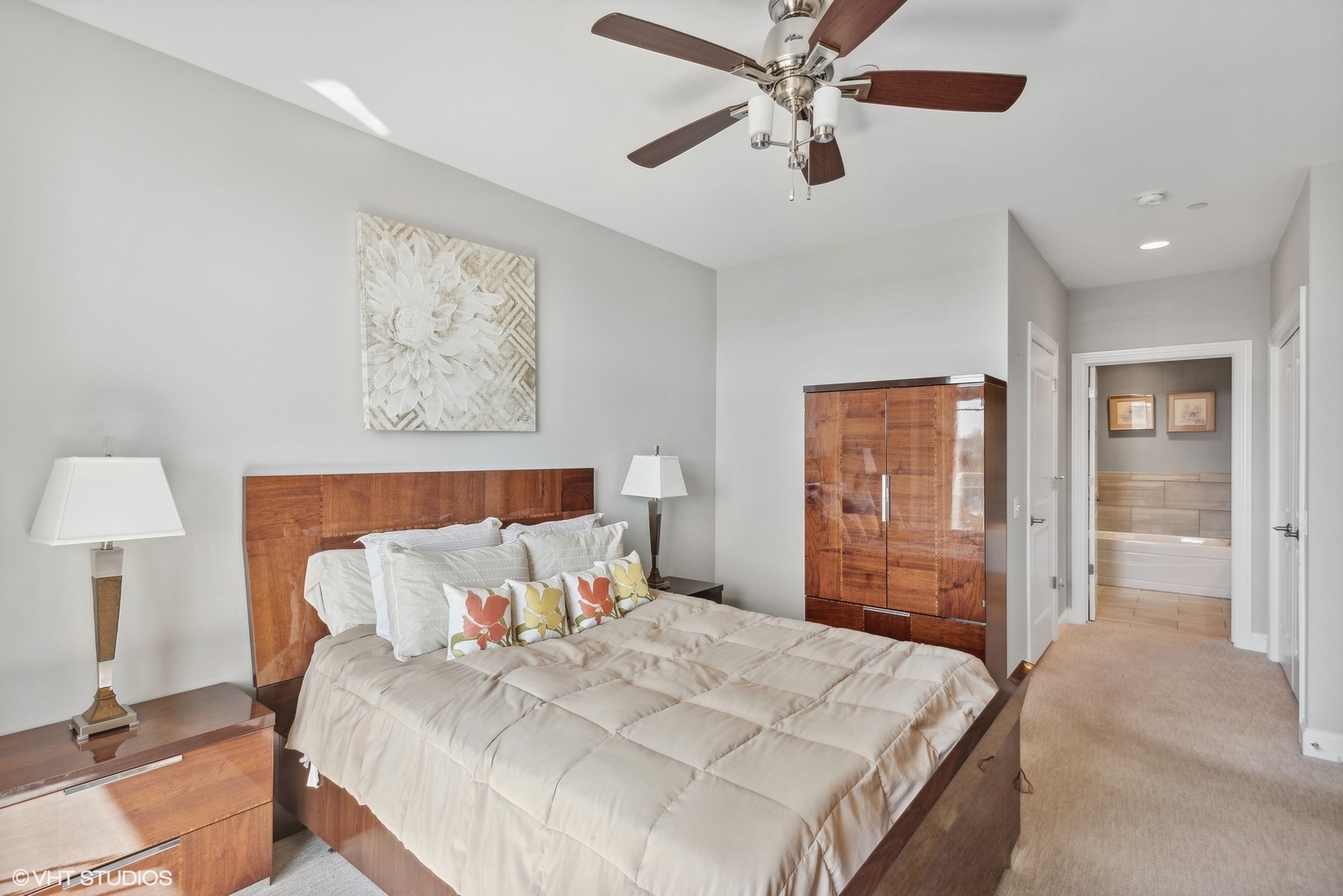 100 Prairie Park Drive, Unit 401 Wheeling, IL 60090 - Photo 15 of 29 a bedroom with a large bed and a chandelier