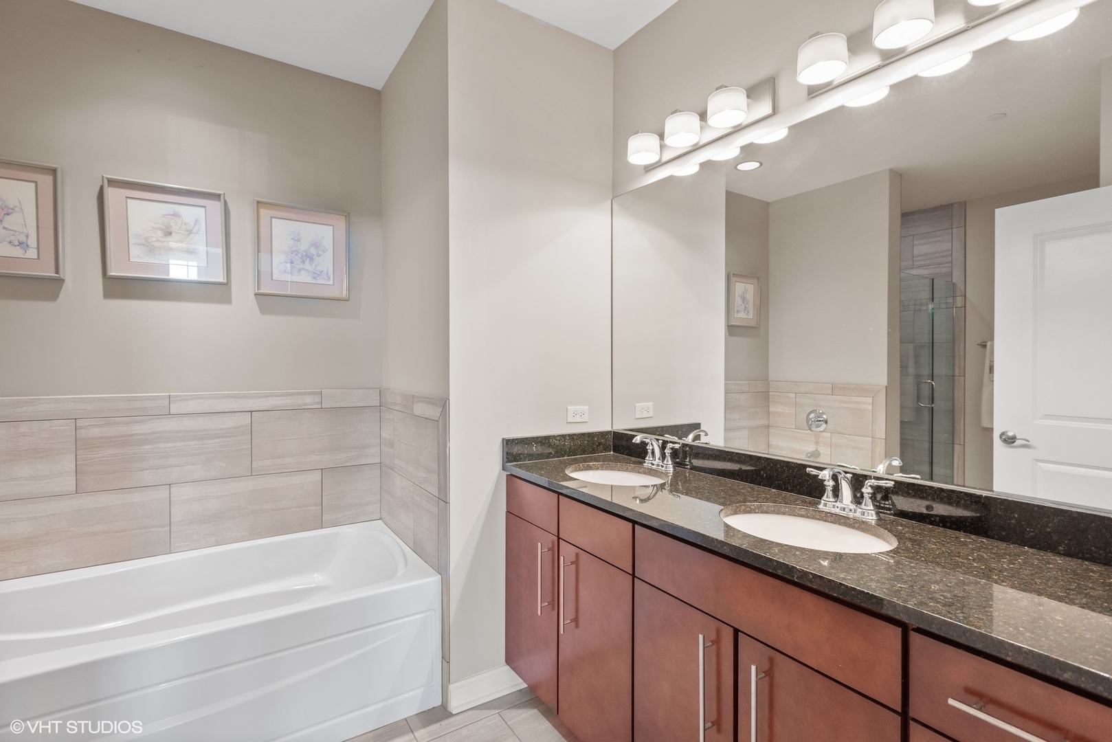 100 Prairie Park Drive, Unit 401 Wheeling, IL 60090 - Photo 16 of 29 a bathroom with a tub a sink and mirror
