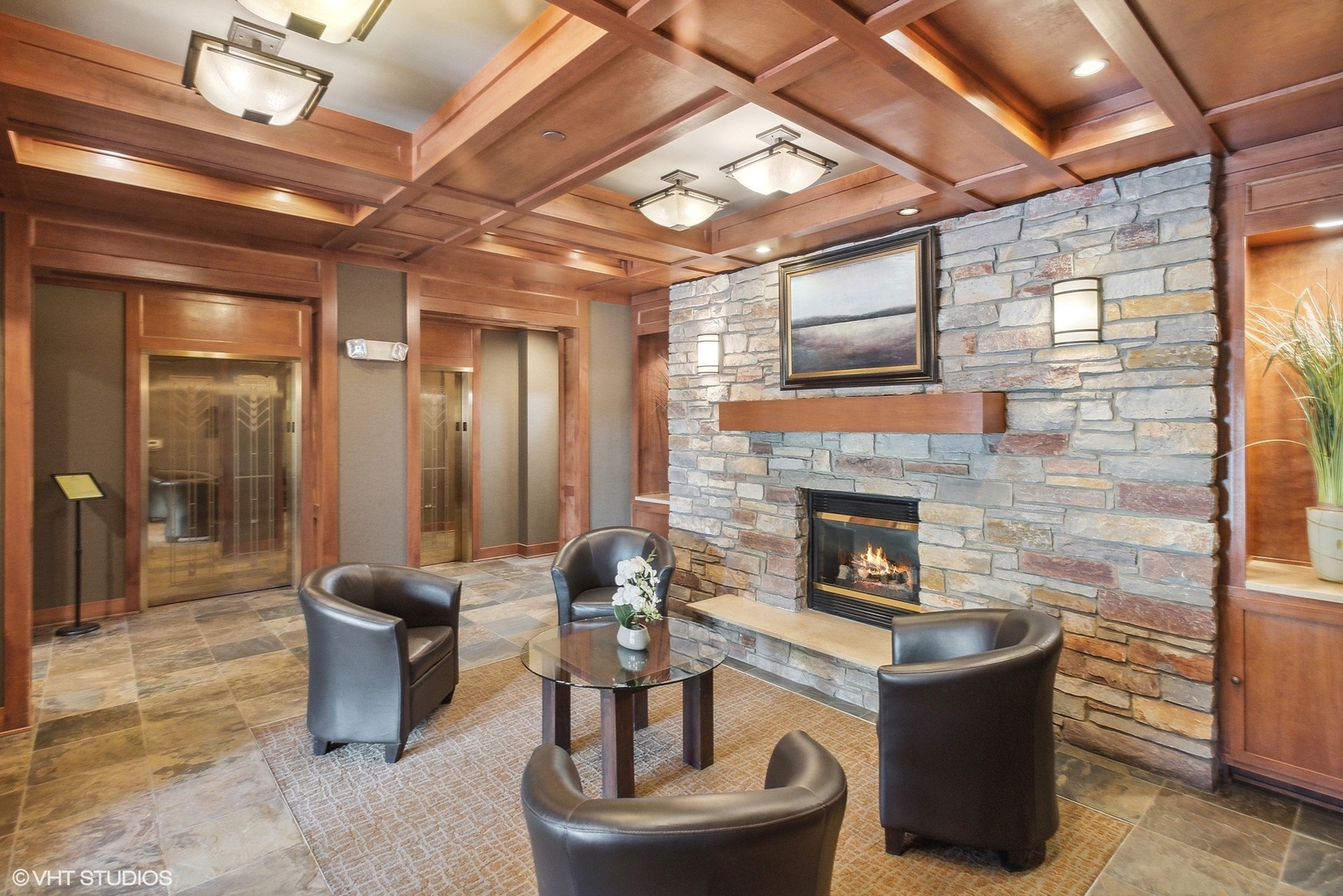 100 Prairie Park Drive, Unit 401 Wheeling, IL 60090 - Photo 2 of 29 a living room with furniture a fireplace and a projector screen