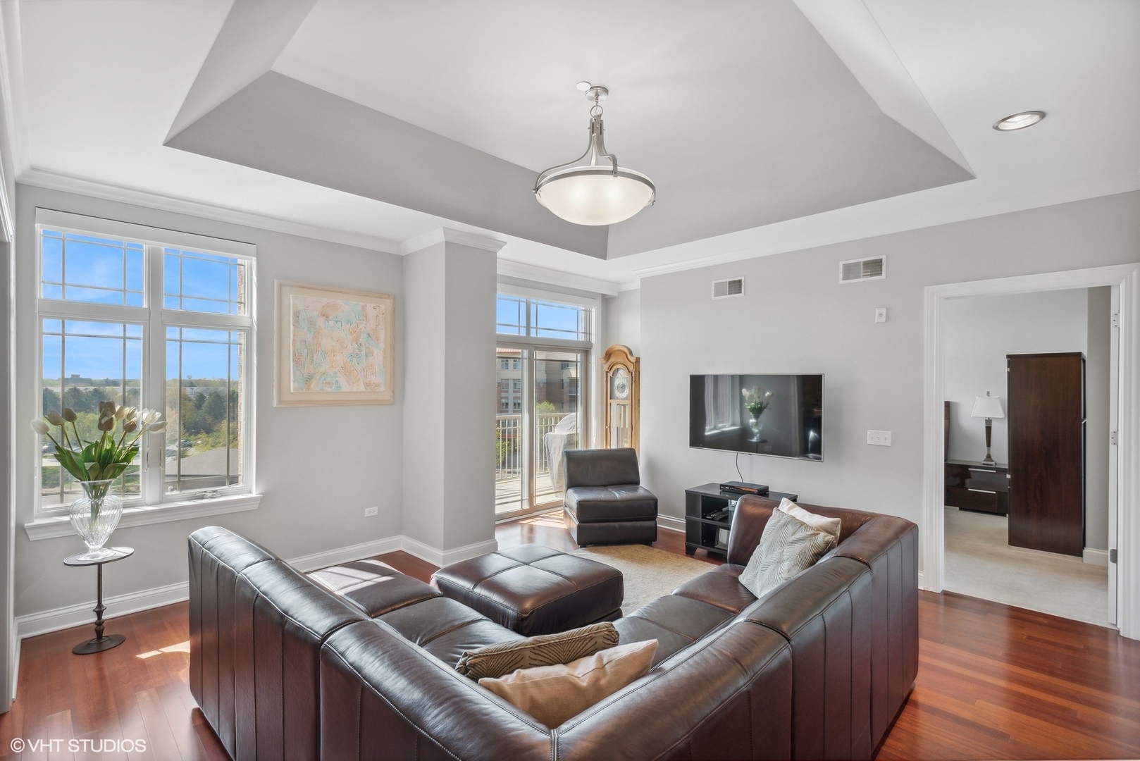 100 Prairie Park Drive, Unit 401 Wheeling, IL 60090 - Photo 3 of 29 a living room with furniture a wooden floor and a large window