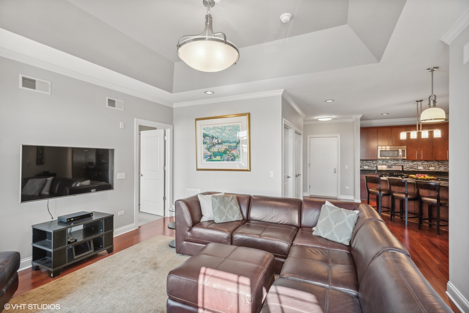 100 Prairie Park Drive, Unit 401 Wheeling, IL 60090 - Photo 5 of 29 a living room with furniture and a flat screen tv