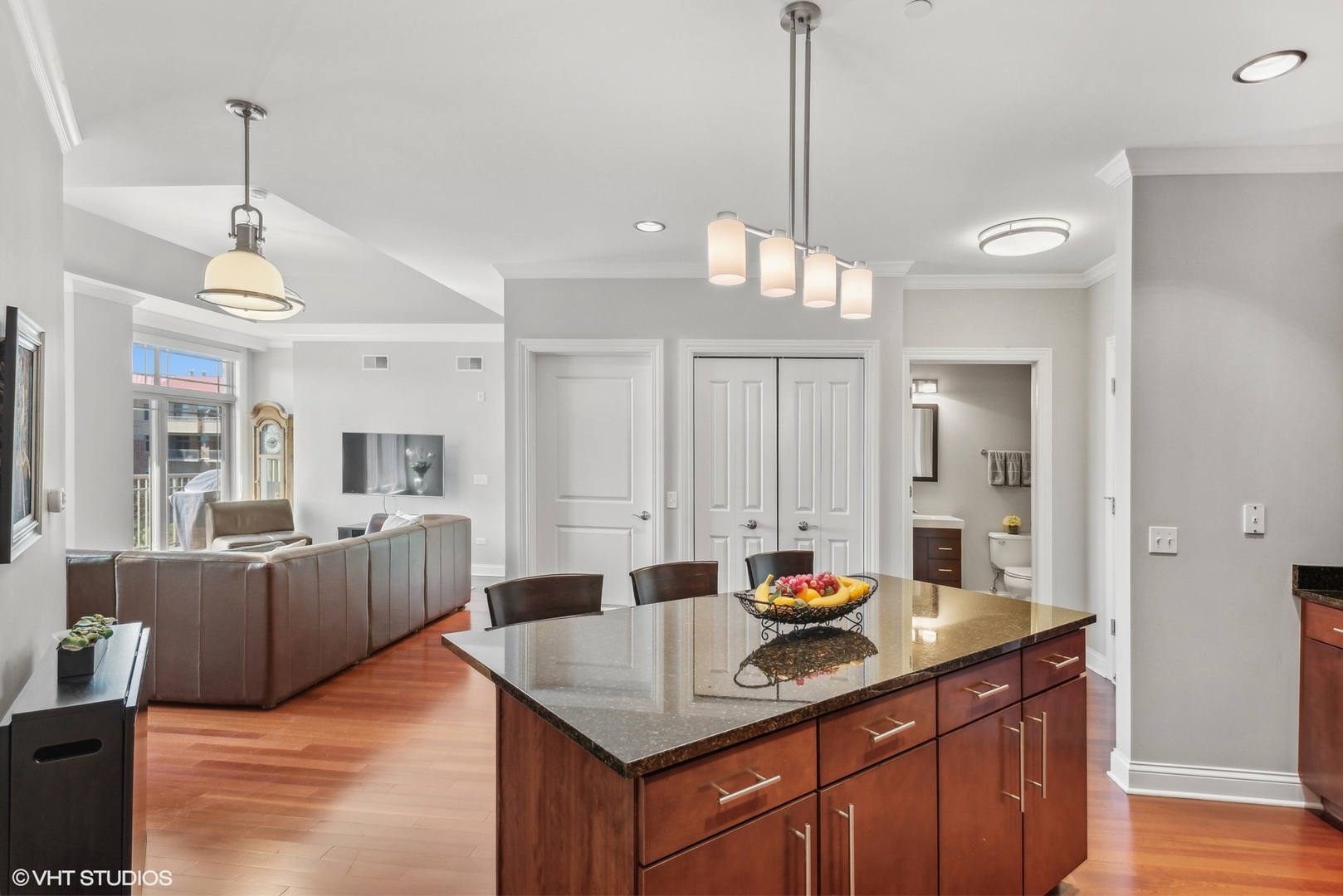 100 Prairie Park Drive, Unit 401 Wheeling, IL 60090 - Photo 9 of 29 a kitchen with stainless steel appliances granite countertop a sink dishwasher a couches with wooden floor
