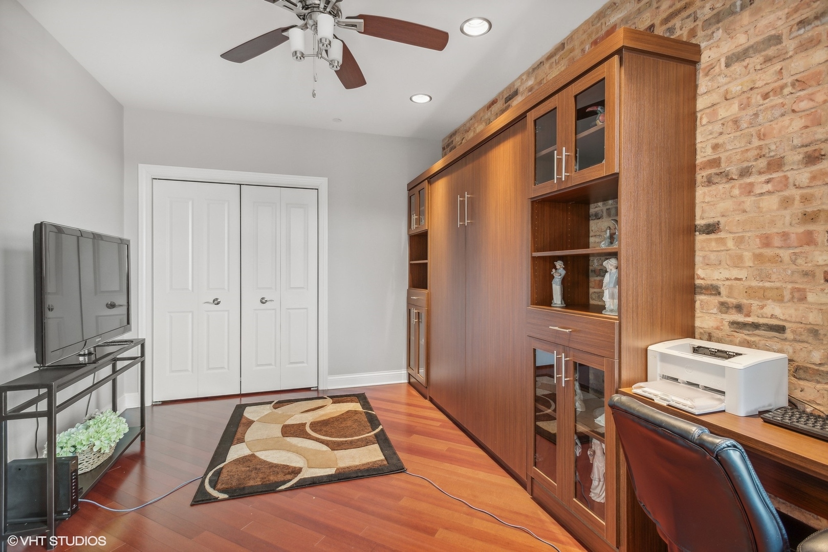 100 Prairie Park Drive, Unit 401 Wheeling, IL 60090 - Photo 10 of 29 a bedroom with a bed and a flat tv screen on dresser