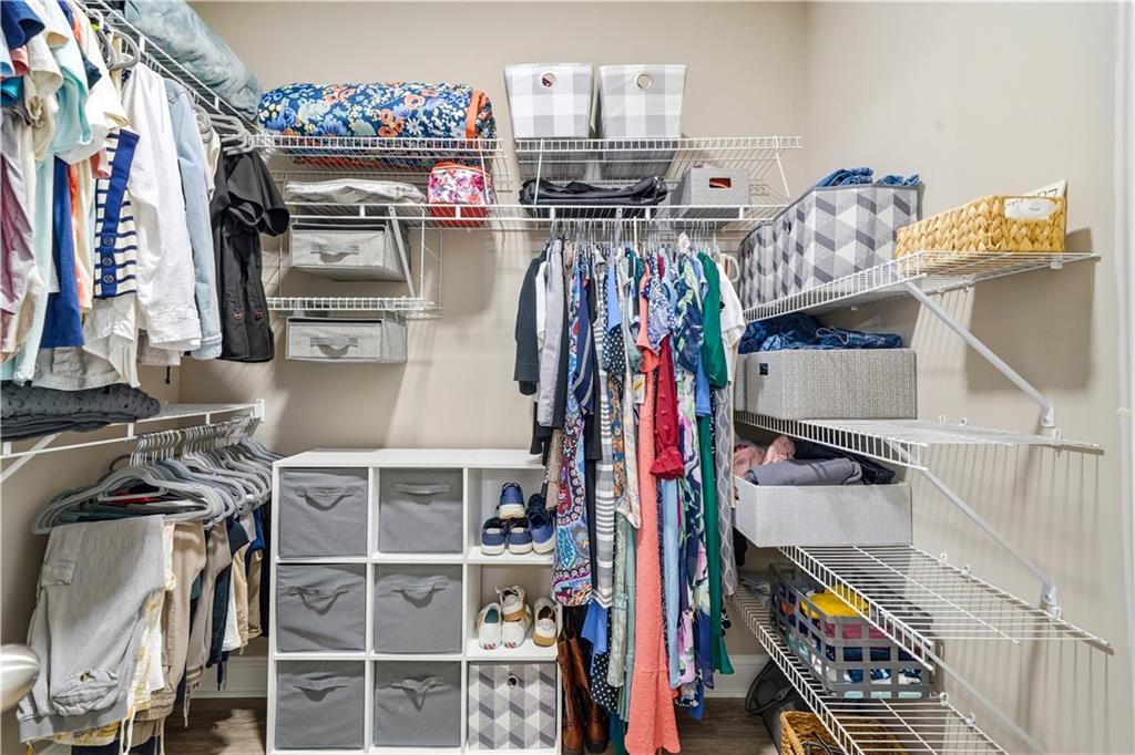 302 Spence Circle Ball Ground, GA 30107 - Photo 26 of 55 a view of walk in closet with clothes and shoes