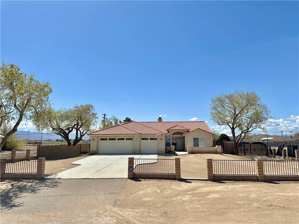 20967 S Road Apple Valley, CA 92307 - Photo 1 of 1 a front view of a house with a yard