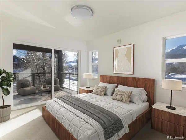 a bedroom with a bed and a lamp