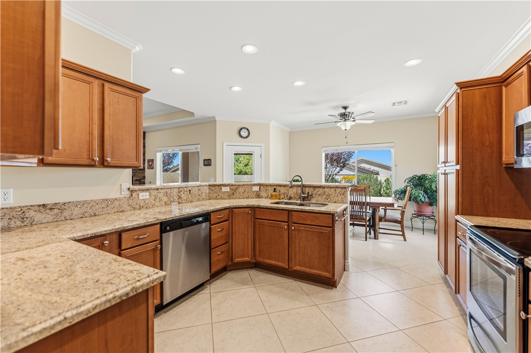 3315 Rainbow Mine Road Kingman, AZ 86401 - Photo 15 of 54 Spacious kitchen featuring light-colored granite countertops, wood cabinetry, and stainless steel appliances