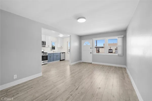 a view of a kitchen with wooden floor and a sink