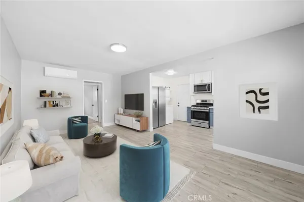 a kitchen with stainless steel appliances a stove a sink and a microwave