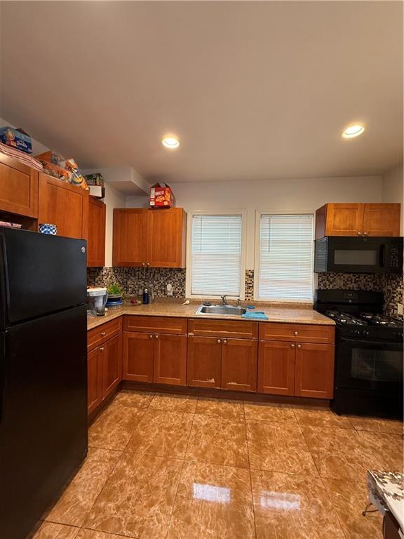1117 Glenwood Road Brooklyn, NY 11230 - Photo 11 of 28 a large kitchen with granite countertop a refrigerator and a stove top oven