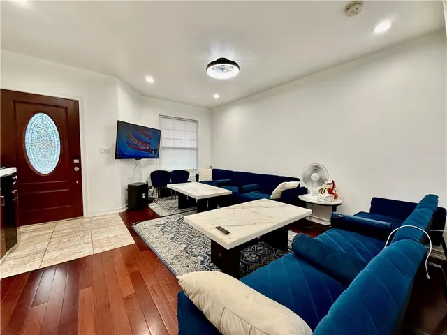 a living room with furniture and a mirror