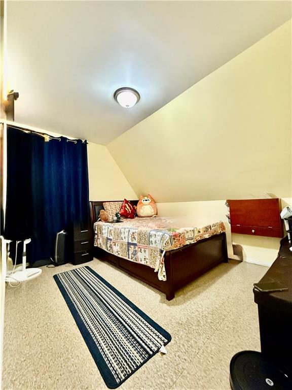 1117 Glenwood Road Brooklyn, NY 11230 - Photo 23 of 28 a bedroom with a bed and dresser with mirror