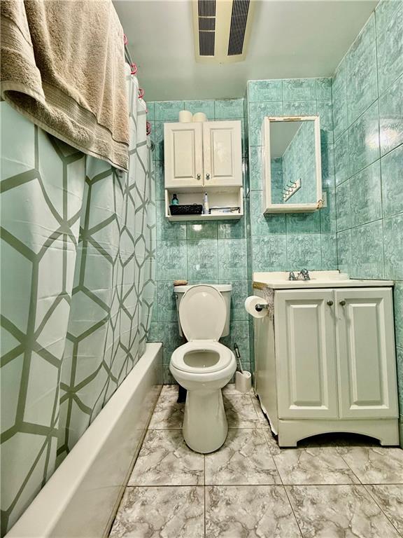 1117 Glenwood Road Brooklyn, NY 11230 - Photo 24 of 28 a bathroom with a toilet sink and mirror
