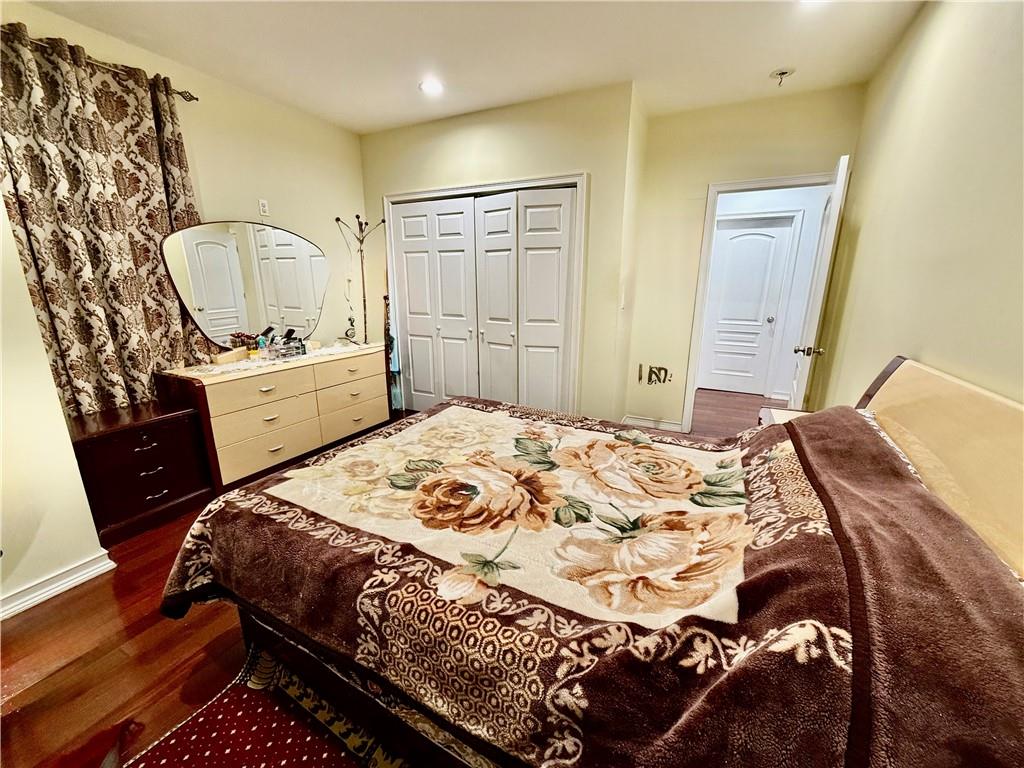 1117 Glenwood Road Brooklyn, NY 11230 - Photo 6 of 28 a bedroom with a bed and wooden floor