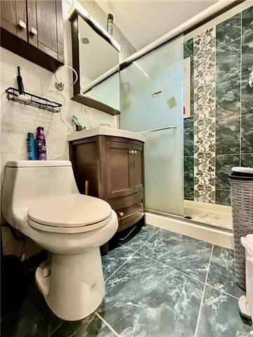 a bathroom with a toilet and a shower