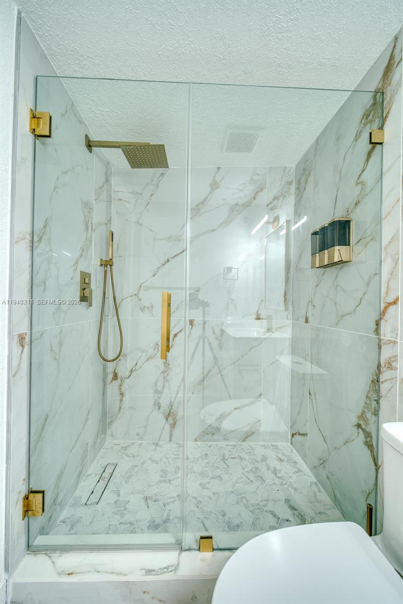 2741 Southwest 67th Avenue, Unit 1 Miami, FL 33155 - Photo 11 of 24 a bathroom with a toilet and shower