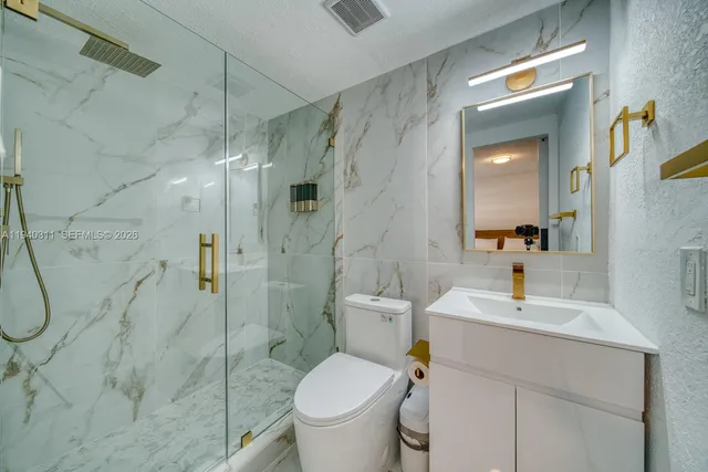 a bathroom with a toilet sink and shower