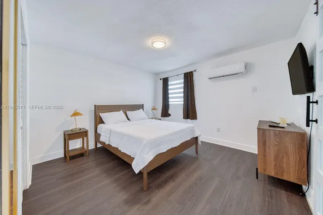 a bedroom with a bed and flat screen tv