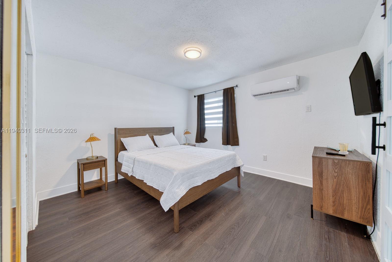 2741 Southwest 67th Avenue, Unit 1 Miami, FL 33155 - Photo 16 of 24 a bedroom with a bed and flat screen tv