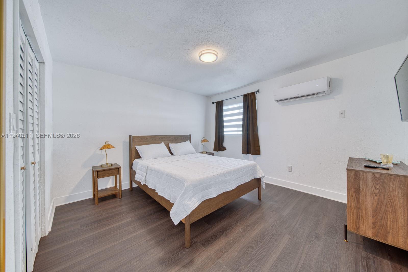 2741 Southwest 67th Avenue, Unit 1 Miami, FL 33155 - Photo 19 of 24 a bedroom with a bed and wooden floor