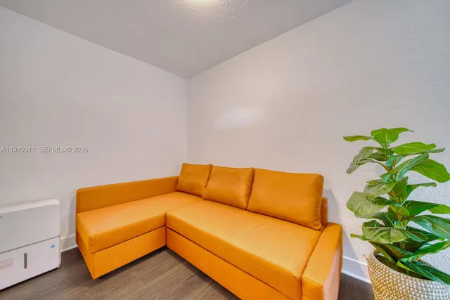 a blue couch sitting in a blue room with a couch