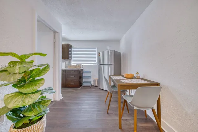 a view of a workspace with furniture and a potted plant