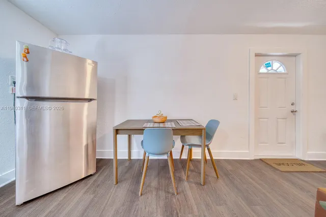 a dining room with furniture and wooden floor