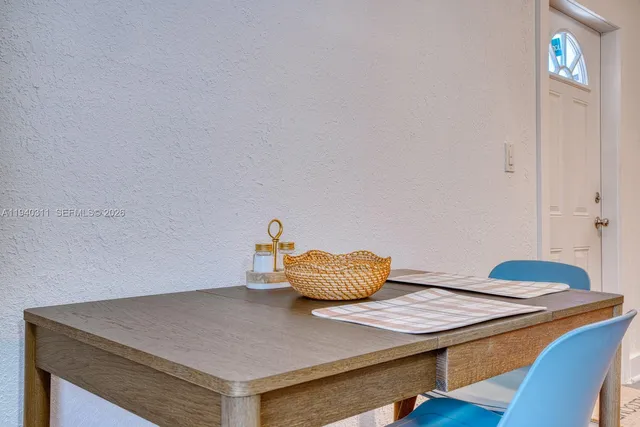 a living room with a table and chairs