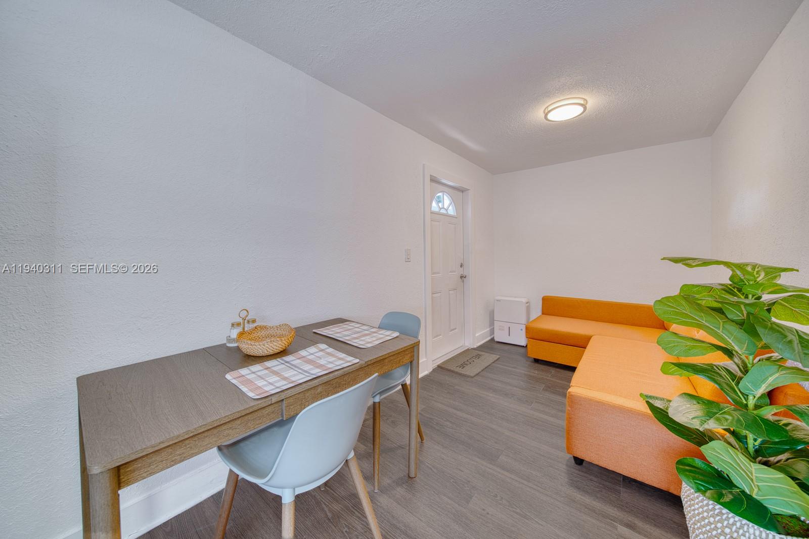 2741 Southwest 67th Avenue, Unit 1 Miami, FL 33155 - Photo 7 of 24 a view of a workspace with a table and chairs in wooden floor