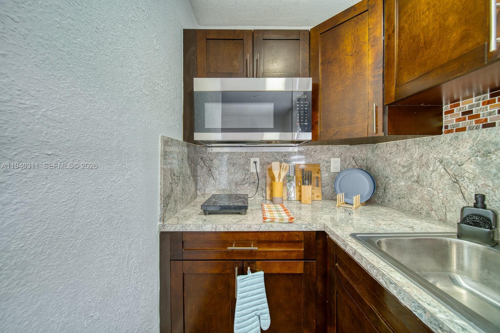 2741 Southwest 67th Avenue, Unit 1 Miami, FL 33155 - Photo 10 of 24 a kitchen with a sink and a microwave oven