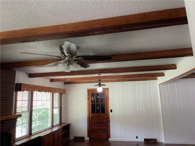 a view of a hallway with furniture and window